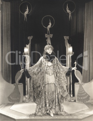 Woman in fur trim outfit with arms outstretched