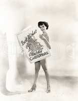 Naked woman covered by a giant Christmas card