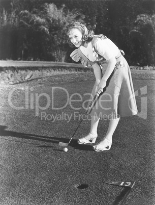 Female golfer about to take a shot