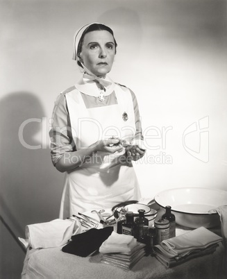 Nurse preparing syringe for injection