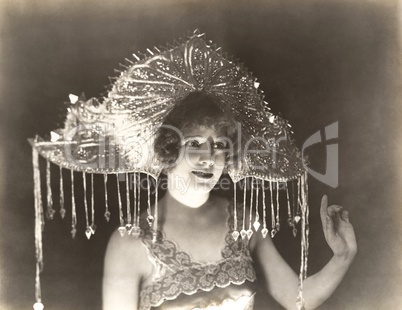 Woman wearing beaded headdress with tassels