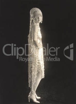 Woman in beaded gown and headdress