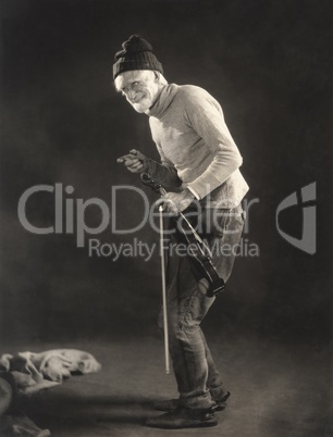 Senior man in woolen cap holding a violin