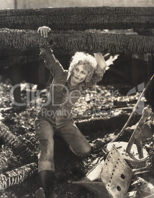 Woman hanging on to fallen logs