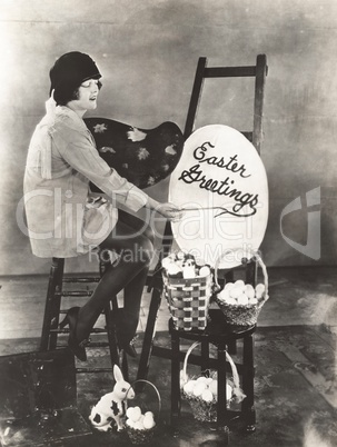 Artist painting an Easter greeting