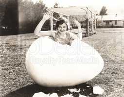 Woman popping out of giant egg