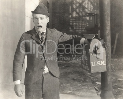 Man with his hand stuck in mailbox