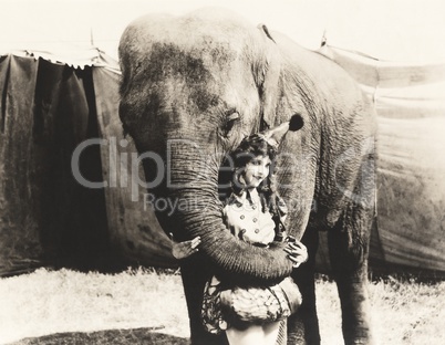 Elephant embracing circus performer