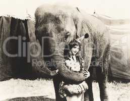 Elephant embracing circus performer