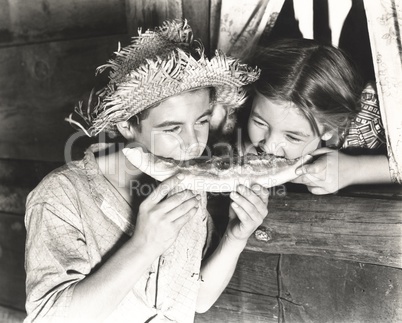 Children sharing slice of watermelon