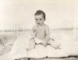 Portrait of baby girl sitting on blanket