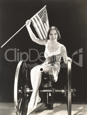Woman on cannon holding American flag