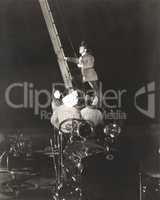Firemen raising ladder on firetruck