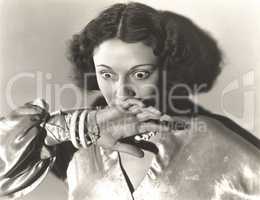Scared woman covering her mouth