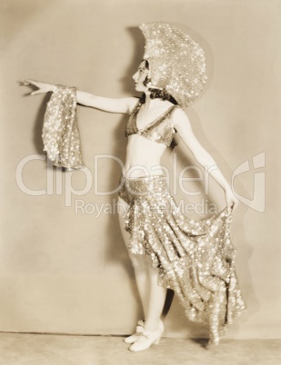 Side view of dancer posing in sparkly costume