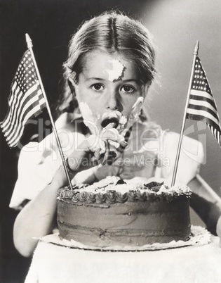 Girl with July 4th cake all over her face