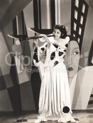 Woman in clown costume playing clarinet