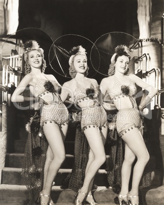 Three dancers in fishnet costumes