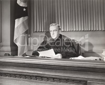 Judge holding a document in courtroom