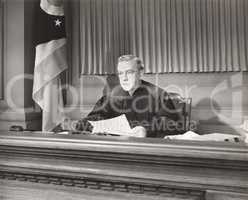 Judge holding a document in courtroom