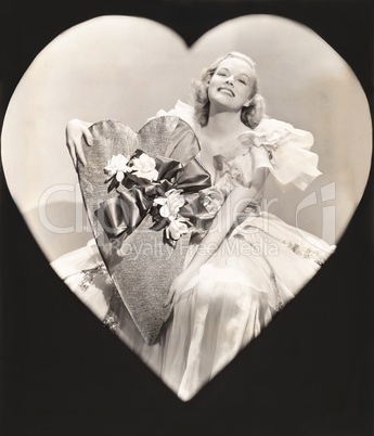 Woman holding a heart-shaped box