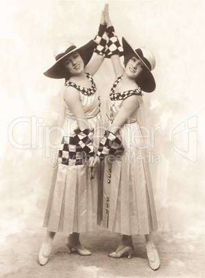 Full length of smiling female dancers performing on stage