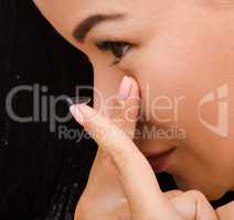 Closeup of woman putting contact lenses