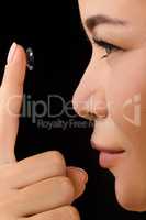 Closeup of woman putting contact lenses