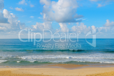 ocean, sandy beach and blue sky