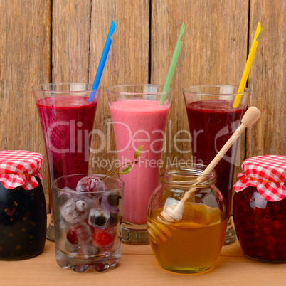 Set of berry smoothies, jams and frozen berries