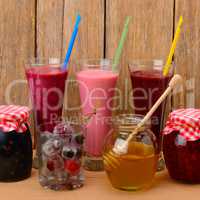 Set of berry smoothies, jams and frozen berries