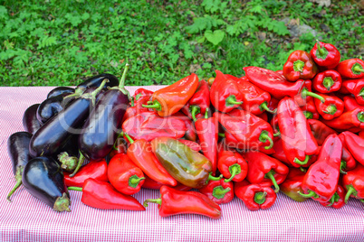 Heap of eggplants and red peppers