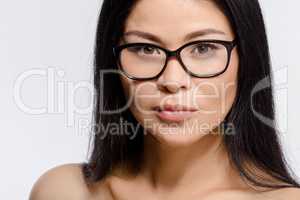 Beautiful Korean woman in glasses in studio