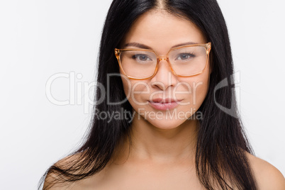 Beautiful Korean woman in glasses in studio