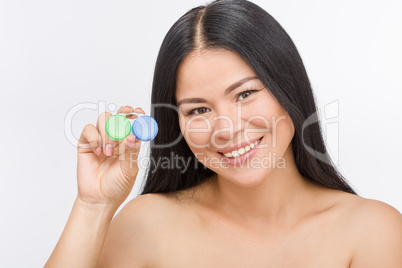 Woman with container for contact lenses