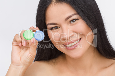 Woman with container for contact lenses