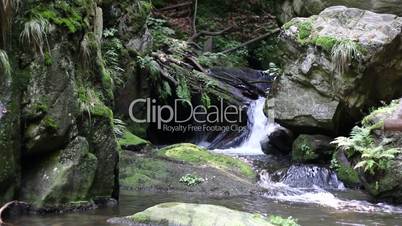 Water flowing between boulders