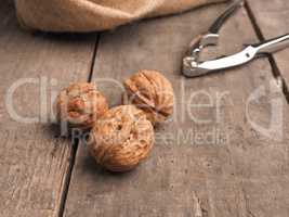 Three walnuts on a wooden table