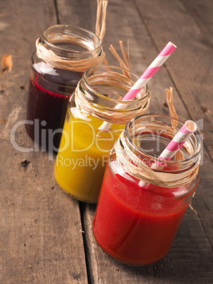 Three healthy smoothie on wood