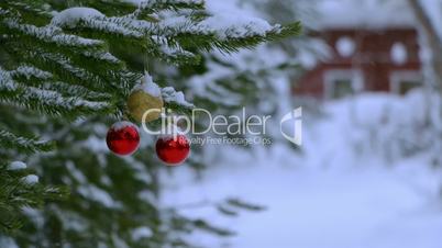 Snowfall and Christmas Balls on the Tree Near the House. Seamless Loop
