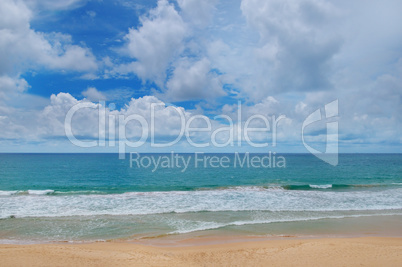 ocean, sandy beach and blue sky