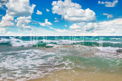 ocean, sandy beach and blue sky