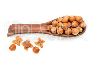hazelnuts in a clay spoon isolated on white background