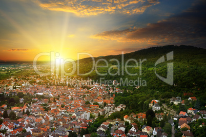 city in a mountain valley and sunrise