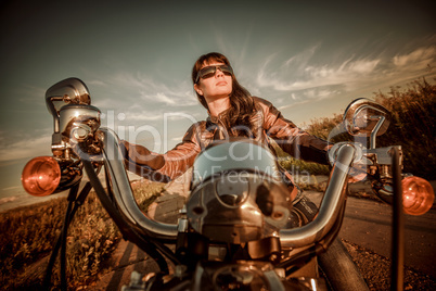 Biker girl sitting on motorcycle