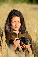 Portrait of young girl with DSLR