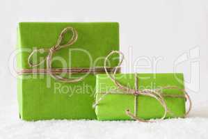 Two Green Gifts Or Presents On Snow, White Background