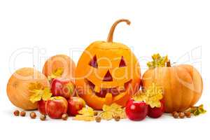 pumpkin-head, nuts, apples and yellow leaves isolated on white b