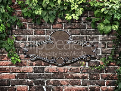 Vintage cast metal plate and climbing plant on the old brick wal
