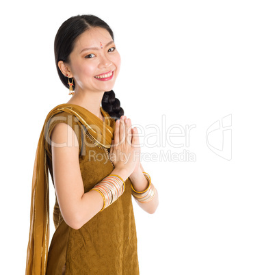 Woman in Punjabi clothes greeting.